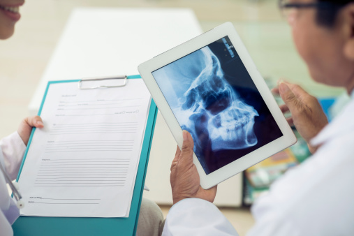 Close-up of Dr. Djawdan examining x-ray at Djawdan Center.